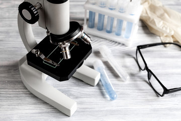 doctors desk with microscope and test tubes