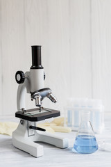 beaker with liquid on background microscope
