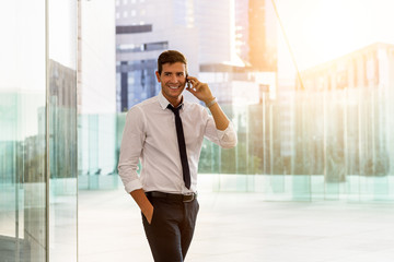 Businessman talking on phone in financial district