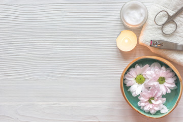 spa nail care with tea candle wooden background top view