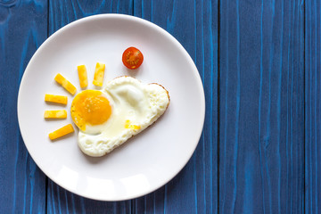 sunshine fried eggs breakfast for kid on blue background