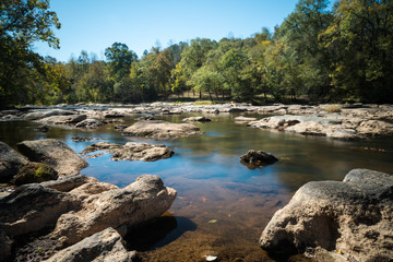 river in South Carolina with rocks in the foreground and forest in the background