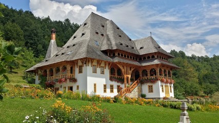 Beautiful traditional house in monastery courtyard. Maramures, Romania