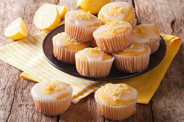 Delicious freshly baked homemade lemon muffins zest sprinkles closeup. Horizontal