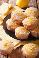 Delicious freshly baked homemade lemon muffins zest sprinkles closeup. vertical
