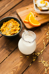 flakes for breakfast and jug of milk top view