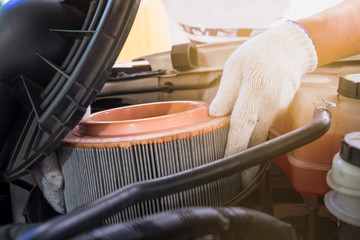 auto mechanic wearing protective work gloves holding a dirty, ai