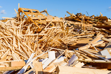 Pile of wooden debris in industrial area. The wood is later shredded to be used as fuel. - 126211690