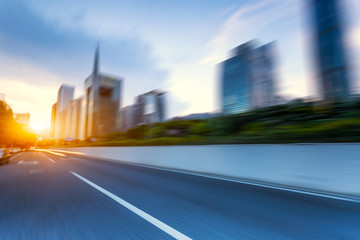 modern buildings in guangzhou from empty asphalt at sunrise