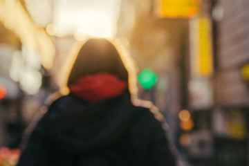 Blur image of unrecognizable female person on the street