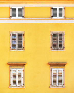 Building facade and old windows with classic wooden shutters bli