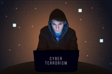 Hacker with laptop initiating cyber attack