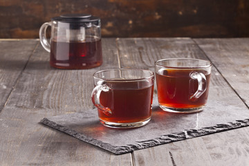 Tea cups and teapot on the wooden table