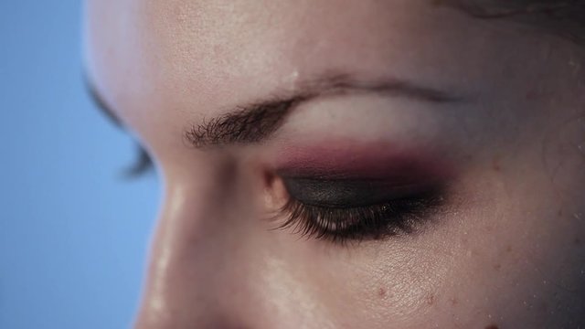Closeup of applying makeup to the eye. Professional and accurate artist.