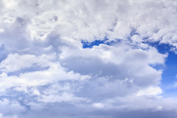Blue sky background with white clouds and rain clouds. The vast blue sky and clouds sky on sunny day. White fluffy clouds in the blue sky.
