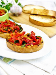 Bruschetta with tomatoes and peppers in plate on napkin