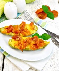 Courgettes in spicy sauce with dried apricots on light board