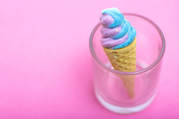 Ice cream waffle cone shape made out of sugar on pink paper, Cop