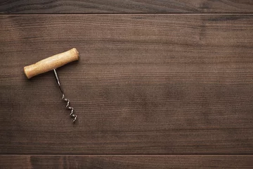 Fotobehang retro wooden corkscrew on the brown table © Ruslan Grumble