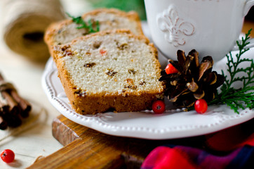 Traditional Christmas cake with dried fruits, raisins and a cup