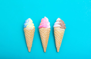 Ice cream waffle cone shape made out of sugar on blue paper, Cop