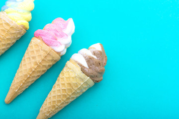 Ice cream waffle cone shape made out of sugar on blue paper, Cop