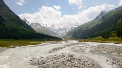 Naklejka na ściany i meble mountain river and valley in Spring in the Swiss Alps