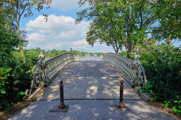 Small bridge in Central Park, New York City, with two metal poles for stopping vehicle traffic