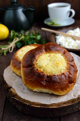 Vanilla cottage cheese buns (cheesecake) on dark wooden background. Close up