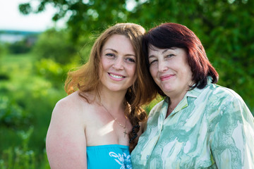 Fototapeta premium smiling mother and daughter in the garden