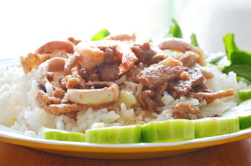 fried garlic pork and seafood with pepper on rice