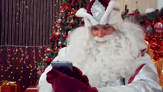 Santa Claus checking list of contacts, soon the new year
