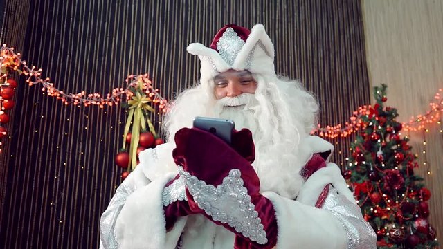 Santa Claus checking list of contacts, soon the new year