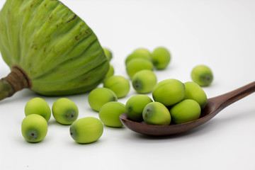 Lotus seeds in wooden spoon.