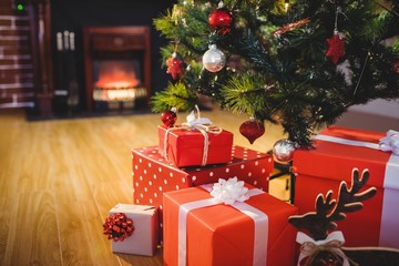 Wrapped gifts near a christmas tree