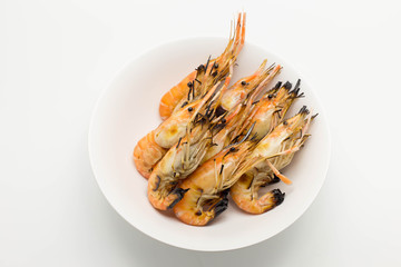 Grilled shrimp in white dish isolated