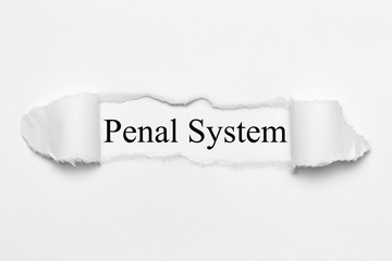 Penal System on white torn paper