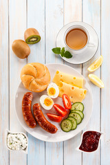 Breakfast - fried sausages, eggs, cheese and vegetables