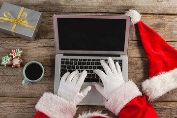 Close-up of santa claus using laptop