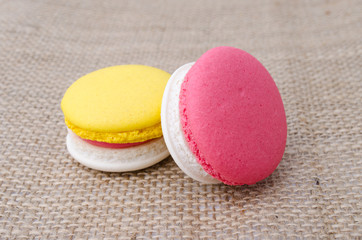 colorful macaroon on glass. sackcloth background