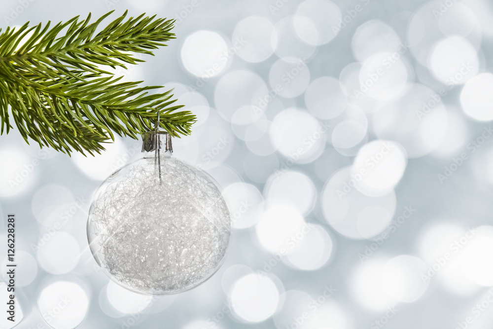 Wall mural white christmas ball hanging from a branch, bokeh background