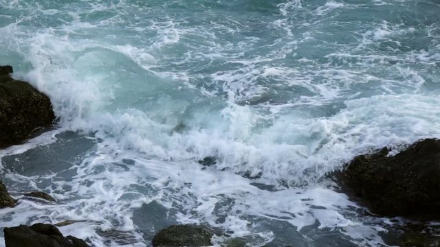 Slow motion of sea swash between boulders. Relax view of water stream, foam, splash and textured rocks. Beautiful background for amazing intro in excellent full HD clip with fourfold deceleration.
