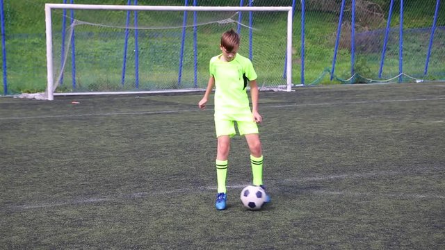 Footballer boy doing tricks with a soccer ball