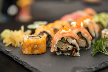 Sushi rolls on a black plate