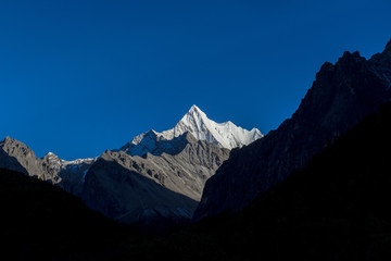 The Holy Snow mountain with blue sky in Yading national reserve at Daocheng County, in the southwest of Sichuan Province, China.