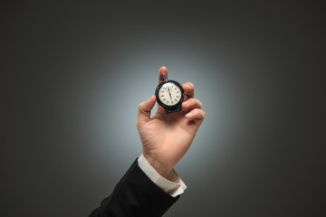 hand holding a stopwatch against a white background