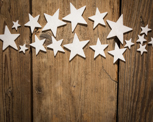 white stars on wooden table. Christmas background