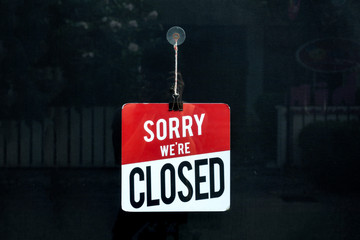 Closed sign in a shop window sorry we are closed.