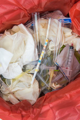 Correct Infectious waste in hospital,Needle and syringes in sharps container,Infectious waste must be disposed of in the trash bag.
