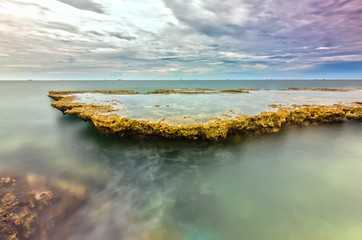 Sea waves crashing on plates sea rocks creating waterfalls and smooth streams water vietnam - seascape.